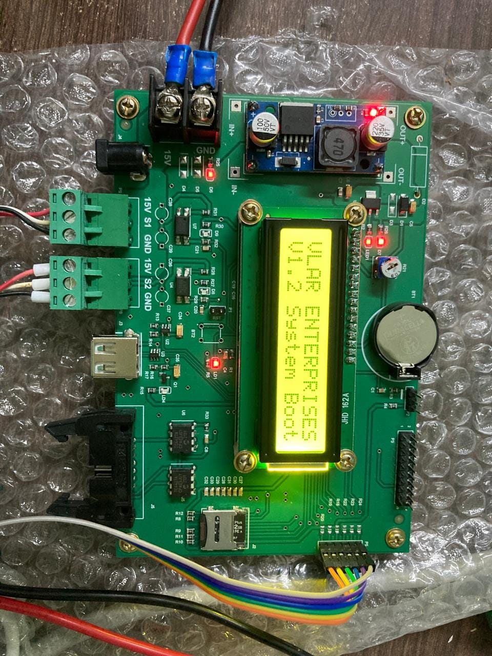 eJacq controller board powered up on the bench, its LCD showing the system boot screen